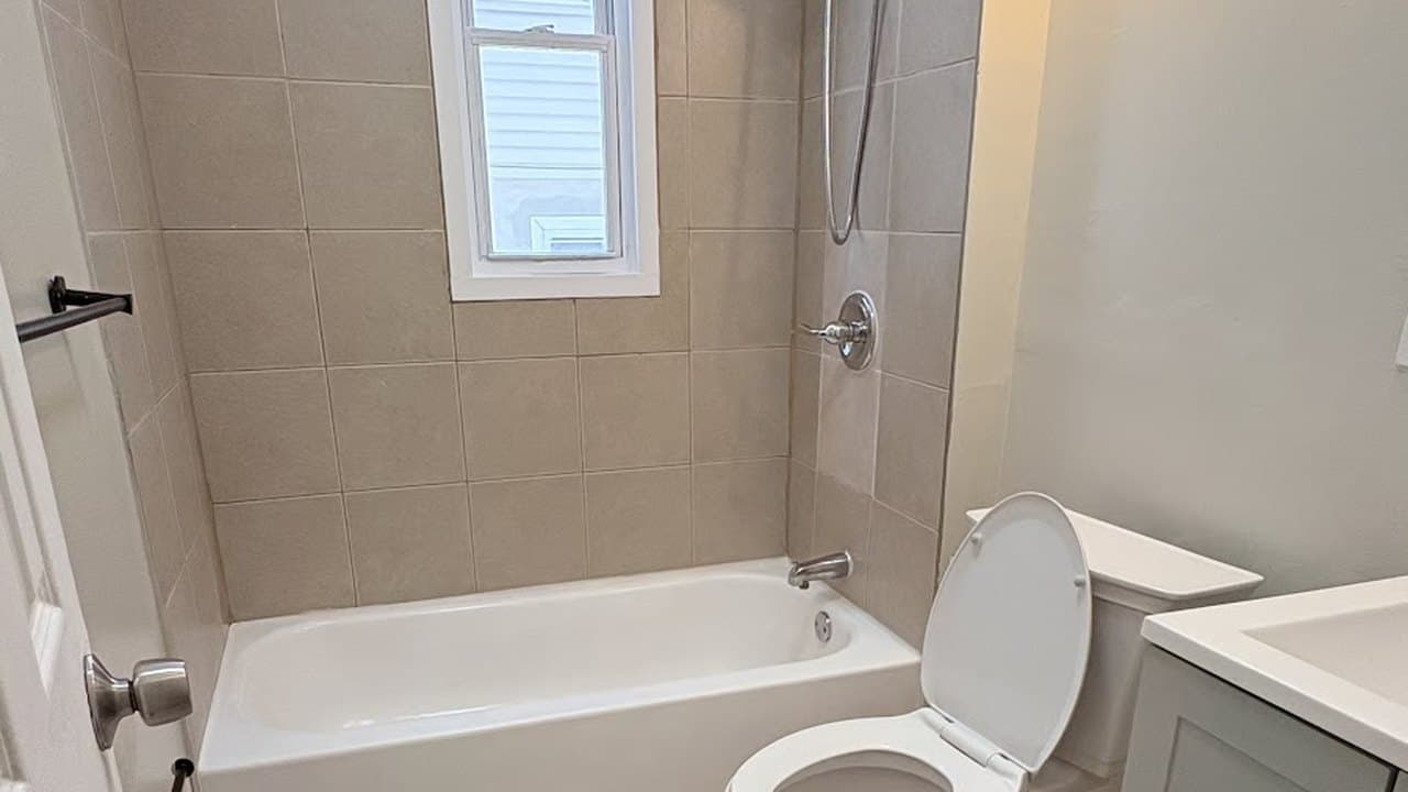 Sanitized bathroom with scrubbed tub, tile, and toilet