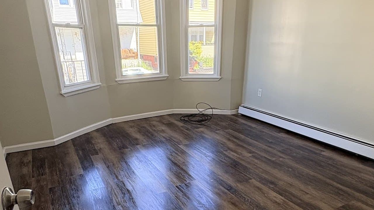 Bay-window room with polished dark hardwood floors
