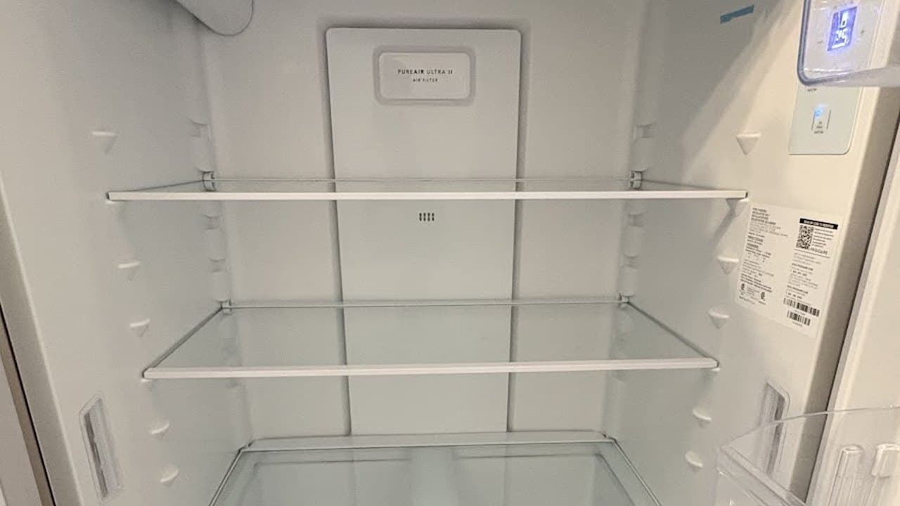 Refrigerator interior cleaned down to empty glass shelves