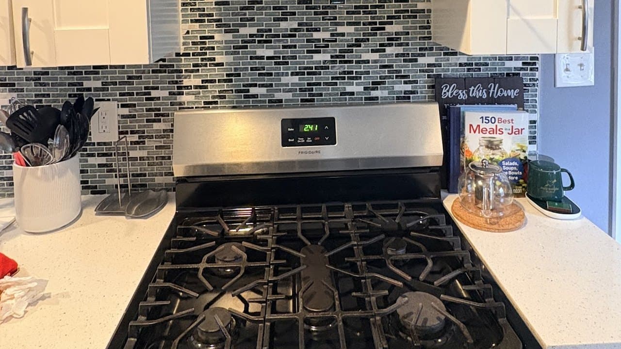 Spotless gas range and mosaic tile backsplash