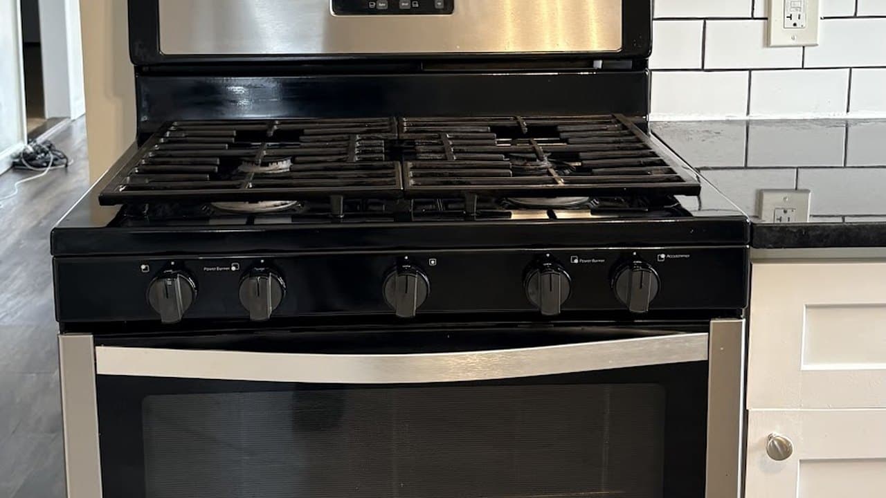 Cleaned gas range and white subway tile backsplash